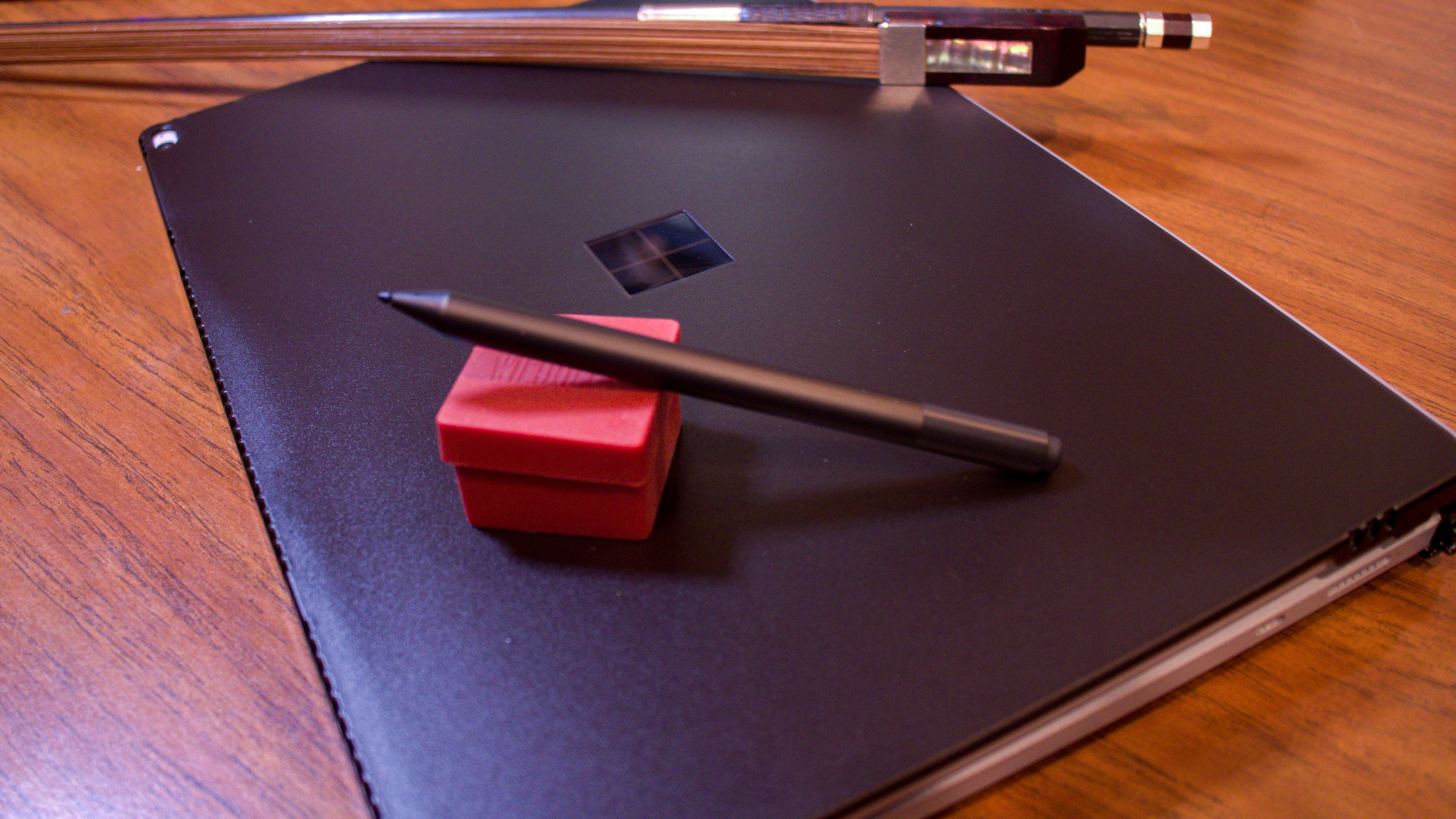 Surface Book 3, a tablet for musicians, sitting on a desk with bass rosin and bass bow.